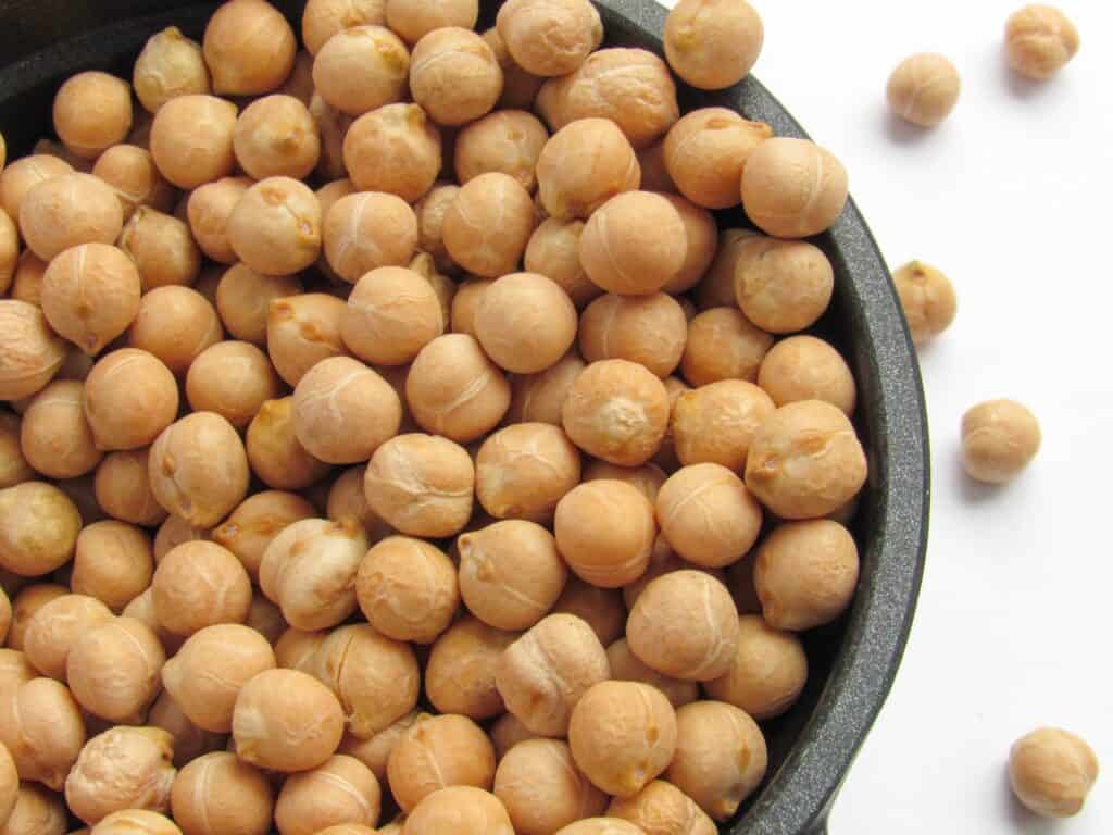 a bowl filled with chickpeas sitting on top of a table